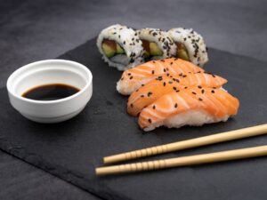 Sushi plate with chopsticks and soya souce.