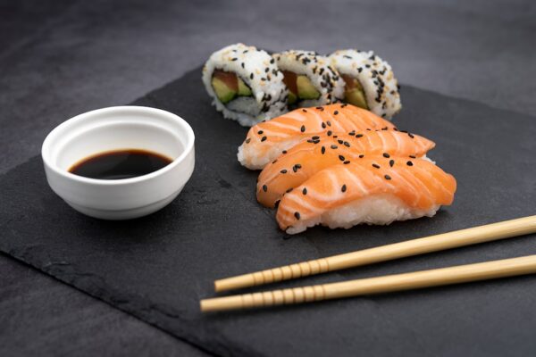 Sushi plate with chopsticks and soya souce.